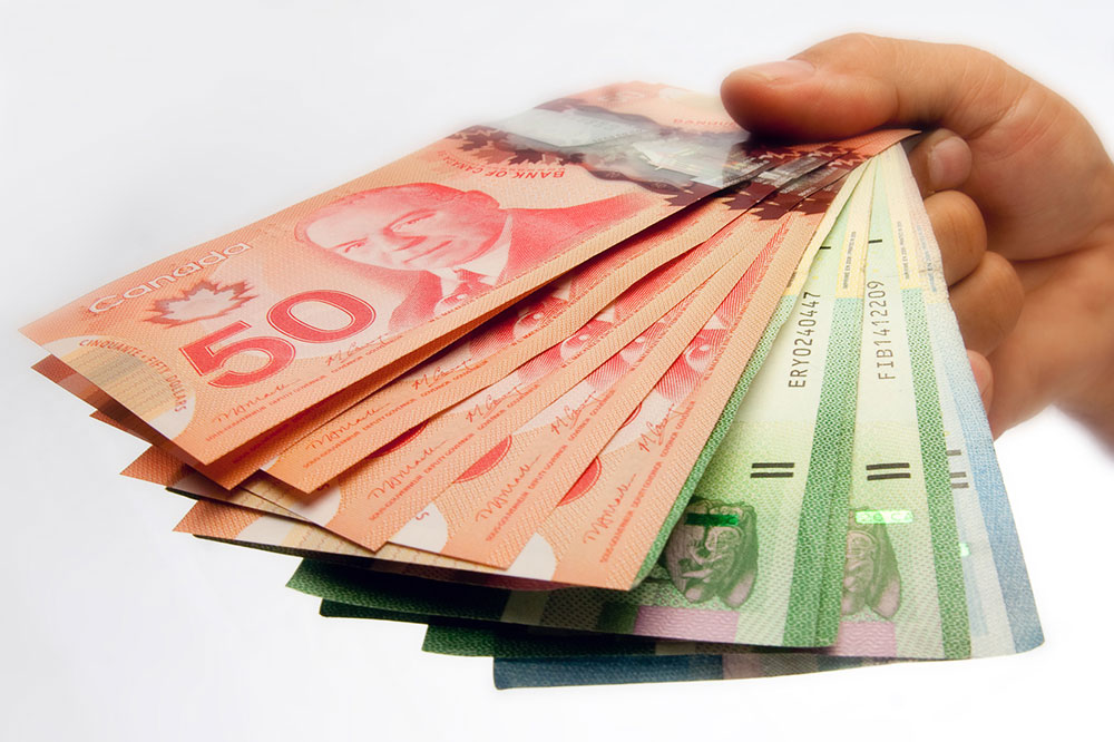 Sube el dólar canadiense por una mejor proyección de la economía de Canadá 